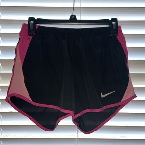 black and pink women’s Nike running shorts